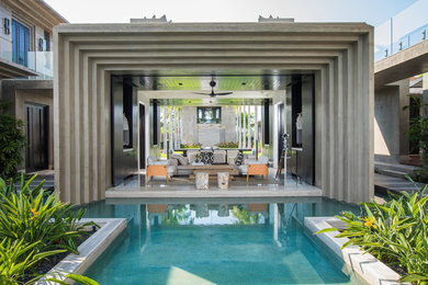 Inspiration for a mid-sized tropical courtyard concrete patio container garden remodel in Mexico City with a gazebo