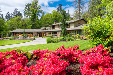 Large contemporary green two-story concrete fiberboard exterior home idea in Portland with a clipped gable roof