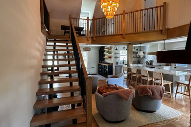 Staircase - craftsman wooden floating metal railing staircase idea in Charleston with wooden risers