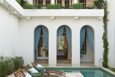 Design ideas for a mediterranean courtyard custom-shaped pool in Miami.