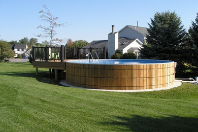 Tuscan backyard concrete aboveground pool photo in New York