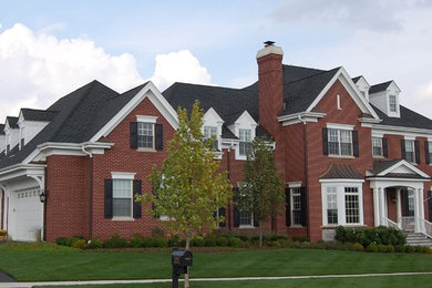 Inspiration for a large timeless red brick exterior home remodel in Chicago