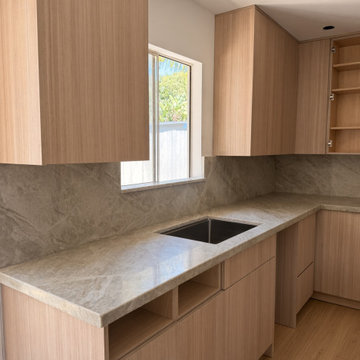 Taj Mahal Quartzite Peninsula Kitchen, Maple Cabinets