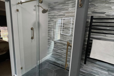 Inspiration for a modern master multicolored tile and porcelain tile porcelain tile, gray floor and double-sink bathroom remodel in Houston with shaker cabinets, gray cabinets, gray walls, an undermount sink, quartz countertops, multicolored countertops and a built-in vanity