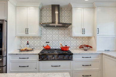 Small transitional u-shaped kitchen photo in San Diego with shaker cabinets, white cabinets, quartz countertops, white backsplash, ceramic backsplash, stainless steel appliances, an island and white countertops