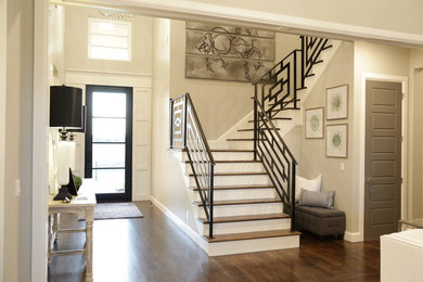 Entryway - mid-sized transitional medium tone wood floor and brown floor entryway idea in Other with beige walls and a glass front door