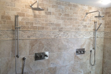 Inspiration for a large timeless master beige tile and stone tile porcelain tile doorless shower remodel in Manchester with shaker cabinets, dark wood cabinets, a one-piece toilet and beige walls