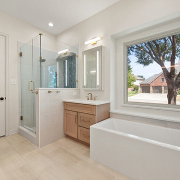 Overview of Modern Primary Bathroom with Walk-In Shower, Soaking Tub, and Oak Va