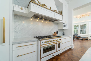 Inspiration for a victorian medium tone wood floor kitchen remodel in San Francisco with recessed-panel cabinets, marble countertops, white backsplash, marble backsplash, an island and white countertops