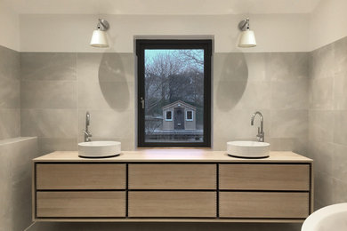 Design ideas for a contemporary bathroom in Gothenburg with wood benchtops.