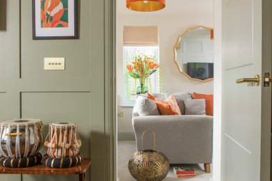 Example of a mid-sized transitional enclosed carpeted, beige floor and wall paneling living room design in Other with beige walls and a media wall