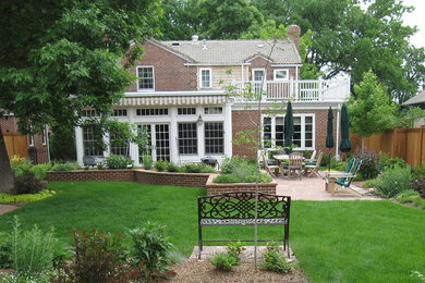 Photo of a traditional backyard garden in Denver with natural stone pavers.