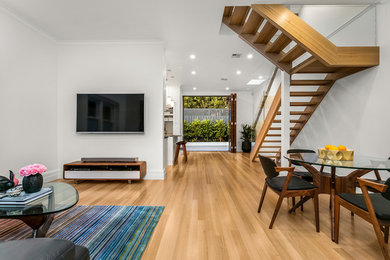 Photo of a contemporary living room in Melbourne with white walls.