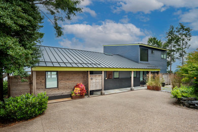 Large modern gray split-level wood and clapboard exterior home idea in Providence with a metal roof and a gray roof