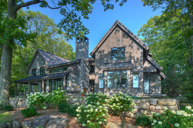 Large rustic brown two-story mixed siding exterior home idea in Other with a shingle roof