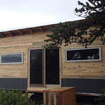 Front facade with ribbon windows, hardy board siding, and beetle kill siding