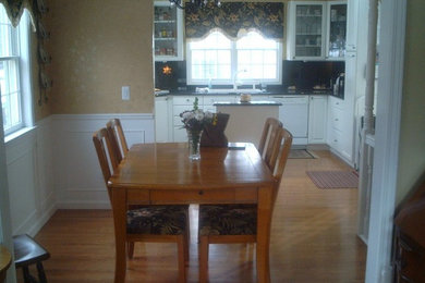 Eat-in kitchen - large medium tone wood floor eat-in kitchen idea in Detroit with recessed-panel cabinets, white cabinets and an island