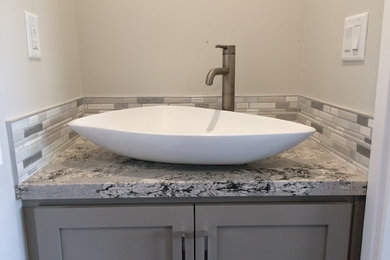 Small transitional 3/4 gray tile, multicolored tile, white tile and matchstick tile bathroom photo in Phoenix with shaker cabinets, gray cabinets, gray walls, a vessel sink and marble countertops