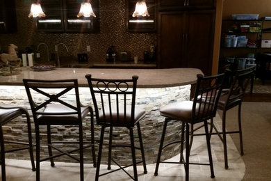 Example of a transitional u-shaped seated home bar design in San Francisco with shaker cabinets, medium tone wood cabinets and gray countertops
