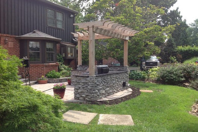 Design ideas for a mid-sized traditional backyard patio in Louisville with an outdoor kitchen, a pergola and concrete pavers.
