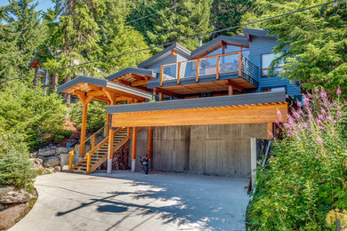 Inspiration for a blue three-story wood house exterior remodel in Vancouver