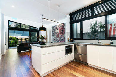 Inspiration for a mid-sized modern u-shaped open plan kitchen in Sydney with a single-bowl sink, beaded inset cabinets, white cabinets, quartz benchtops, grey splashback, stainless steel appliances, no island and grey benchtop.