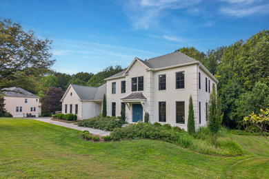 Contemporary gray two-story house exterior idea in DC Metro with a shingle roof and a gray roof