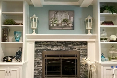 Photo of a traditional living room in Cleveland with a standard fireplace and a stone fireplace surround.