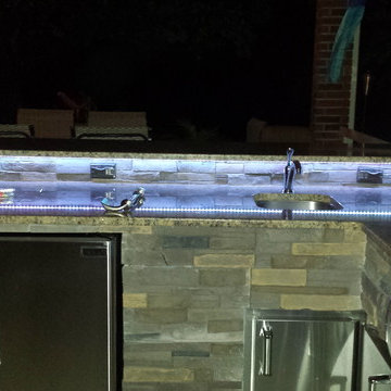 L Shaped Outdoor Kitchen With Unique Lighting