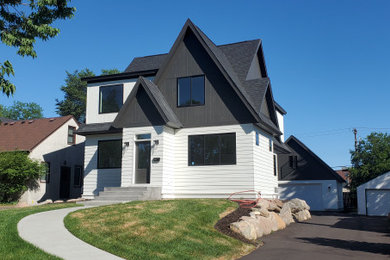 Example of a mid-sized transitional multicolored three-story mixed siding and board and batten exterior home design in Minneapolis with a shingle roof and a black roof