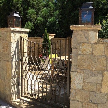 Custom gate with gas lanterns.  Limestone.