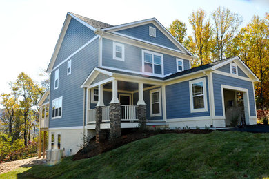 Large craftsman blue two-story concrete fiberboard exterior home idea in Other