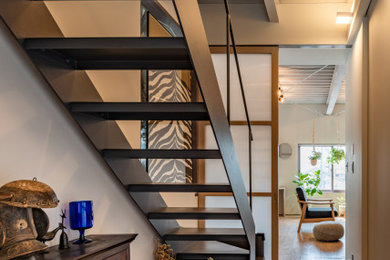 Imagen de escalera recta moderna con escalones de metal, contrahuellas de metal, barandilla de metal y machihembrado