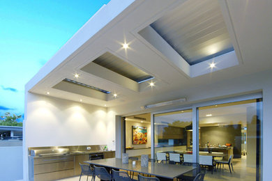Design ideas for a contemporary patio in Perth with a roof extension and tile.