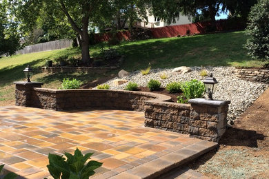 Large country backyard patio in Wilmington with concrete pavers and no cover.