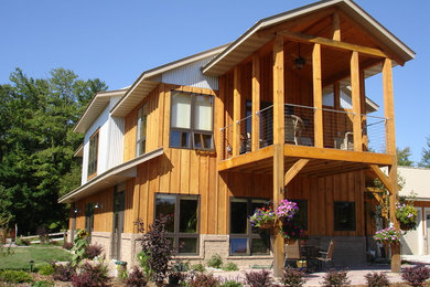 Large trendy two-story mixed siding exterior home photo in Other