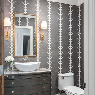 Transitional dark wood floor and brown floor powder room photo in Chicago with flat-panel cabinets, gray cabinets, a one-piece toilet, gray walls, a vessel sink and white countertops