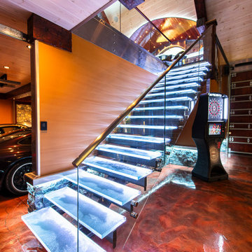 Glass private bar and glass stair treads inside a man cave in Michigan