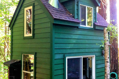 Diseño de fachada verde y marrón rural pequeña de dos plantas con revestimiento de aglomerado de cemento, tejado a dos aguas, microcasa y tejado de teja de madera