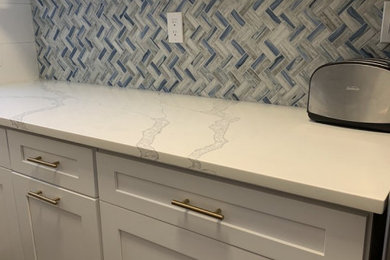 Inspiration for a transitional kitchen in New York with shaker cabinets, quartz benchtops, blue splashback, mosaic tile splashback and white benchtop.