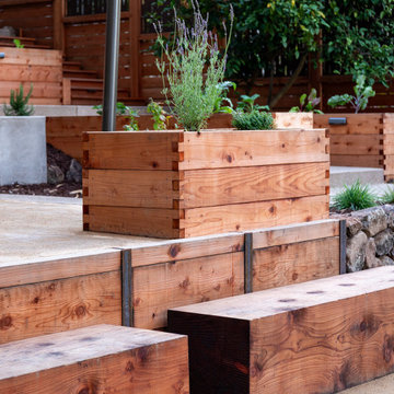 Wood timber benches, retaining wall, and raised beds