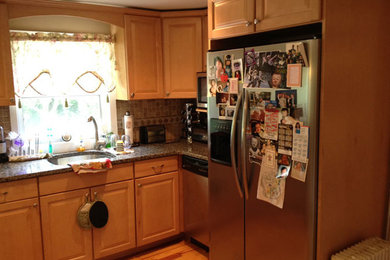 Kitchen - traditional medium tone wood floor kitchen idea in Boston with a drop-in sink, medium tone wood cabinets, beige backsplash, ceramic backsplash and stainless steel appliances