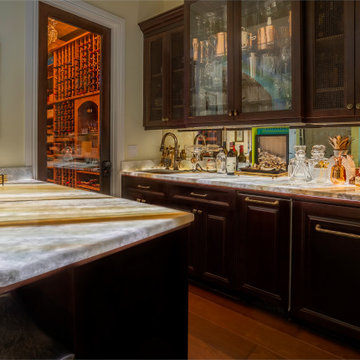 Elegant Wet Bar with Dark Cabinetry and Marble Countertops