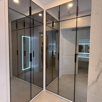 Modern Walk-In Closet – Black Framed Smoked Glass Sliding Wardrobe System