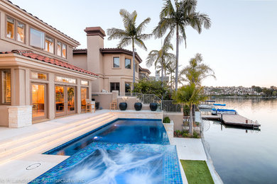 Mid-sized trendy infinity pool photo in Orange County