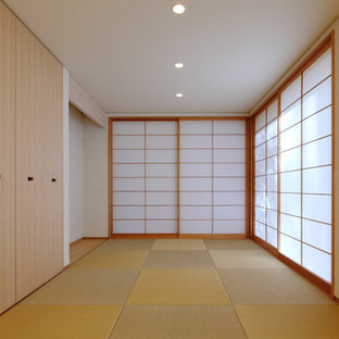 This is an example of an asian home office in Other with white walls, tatami floors and green floor.