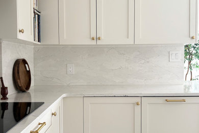 Eat-in kitchen - transitional galley porcelain tile and white floor eat-in kitchen idea in Ottawa with an undermount sink, shaker cabinets, white cabinets, quartz countertops, white backsplash, quartz backsplash, stainless steel appliances, a peninsula and white countertops