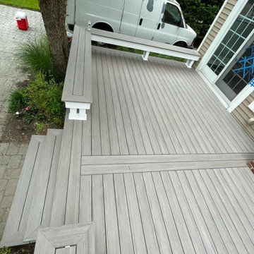Trex deck with picture frame stairs, and bench.