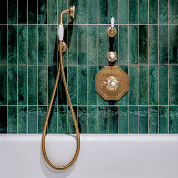 A close up of unlacquered Perrin and Rowe shower fixtures