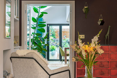 Inspiration for an eclectic open plan living room in London with medium hardwood flooring.